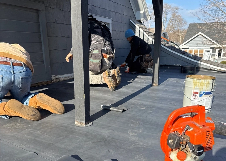 Johnson Restoration workers on flat EPDM roof repair
