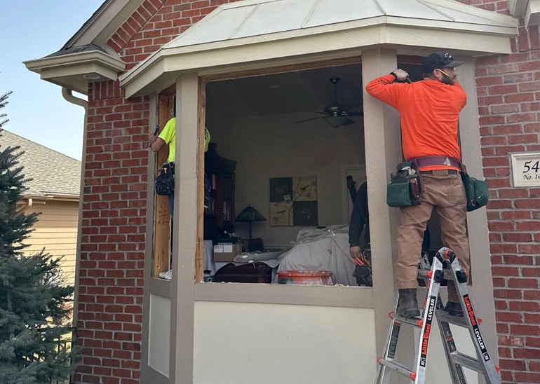 Johnson Restoration workers installing window